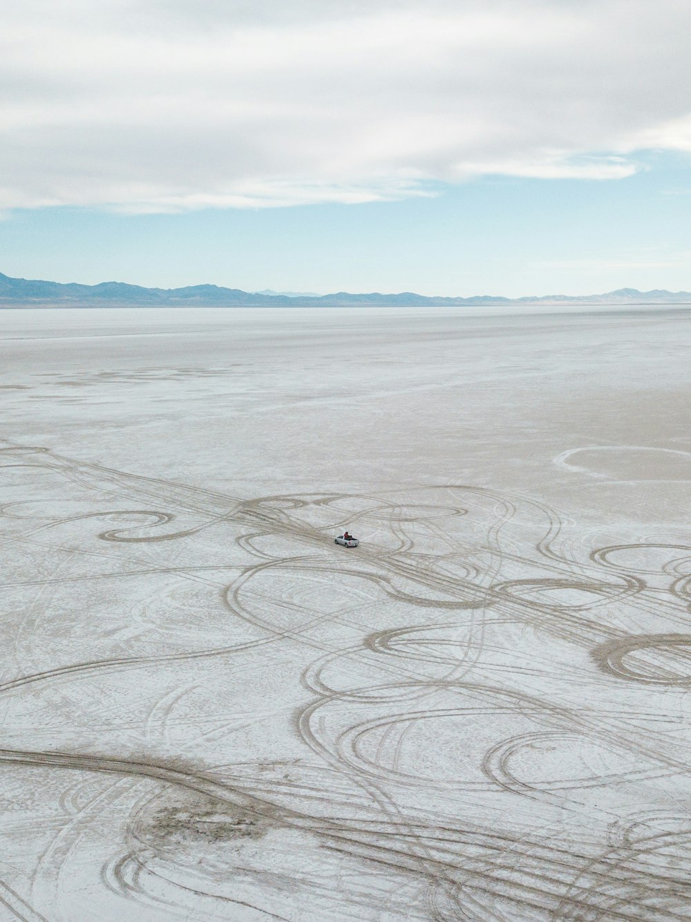 vehicle travelling on open field during daytime aerial photography