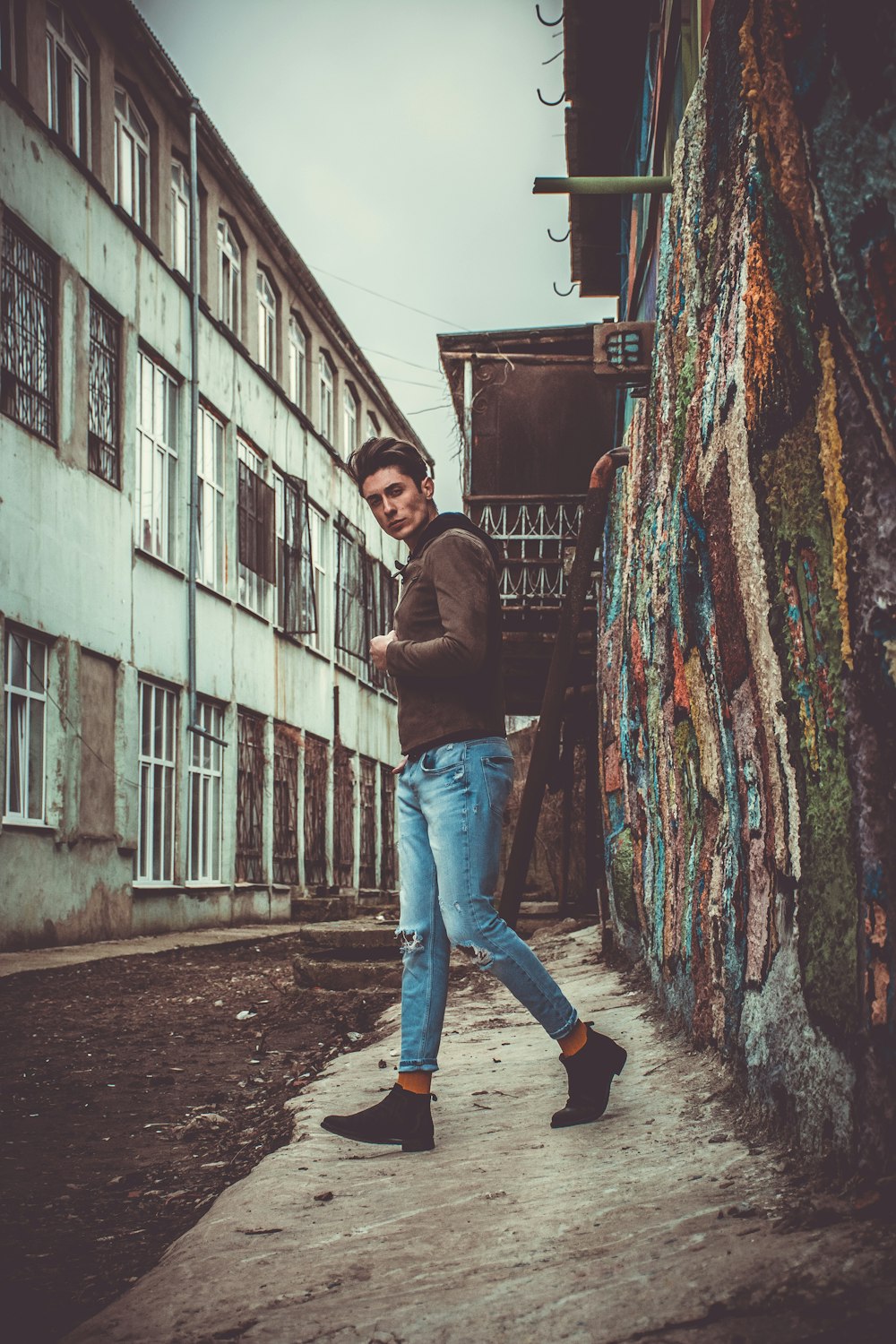 man standing in front of graffiti wall