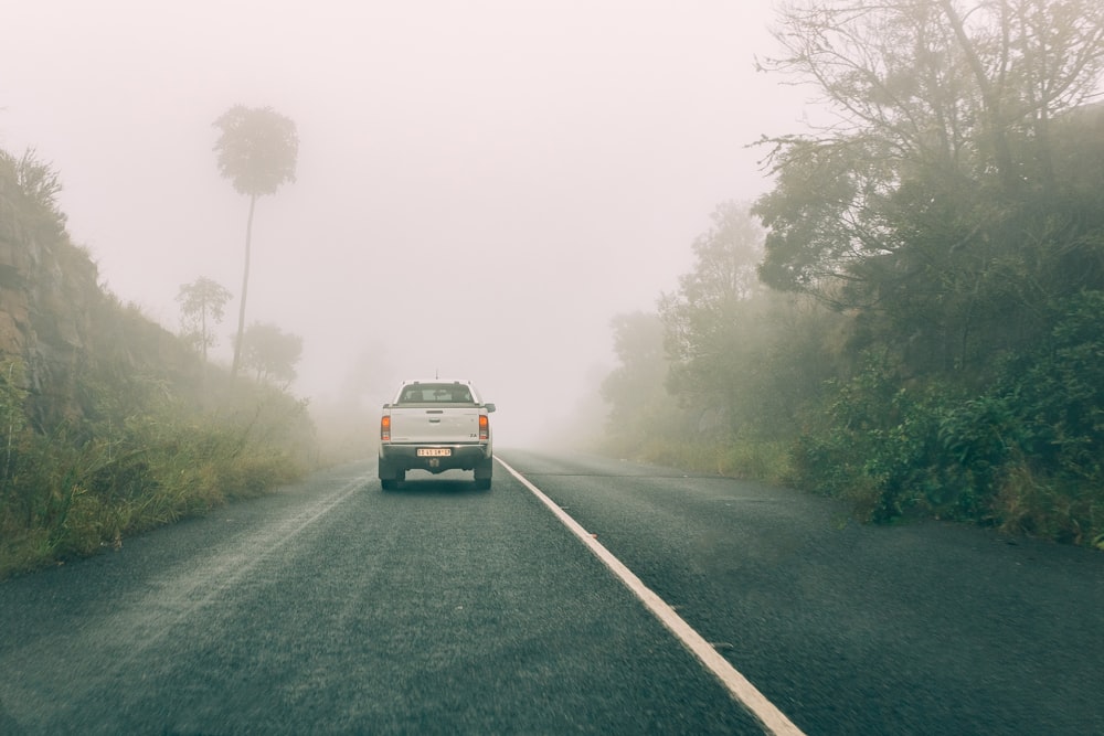 white van on road during foggy weather