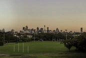 Skyline of Newcastle with a futsal ball in the foreground, blending city and sport.