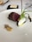 A gourmet dish featuring a piece of medium-rare meat and a root vegetable with charred greens on a white plate. Accompanied by a small dollop of mustard and some seeds. A slab of butter is on a square black dish in the background along with a piece of bread and cutlery.