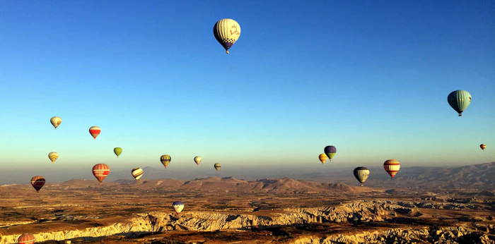 Hot air balloons drifting above Cappadocia