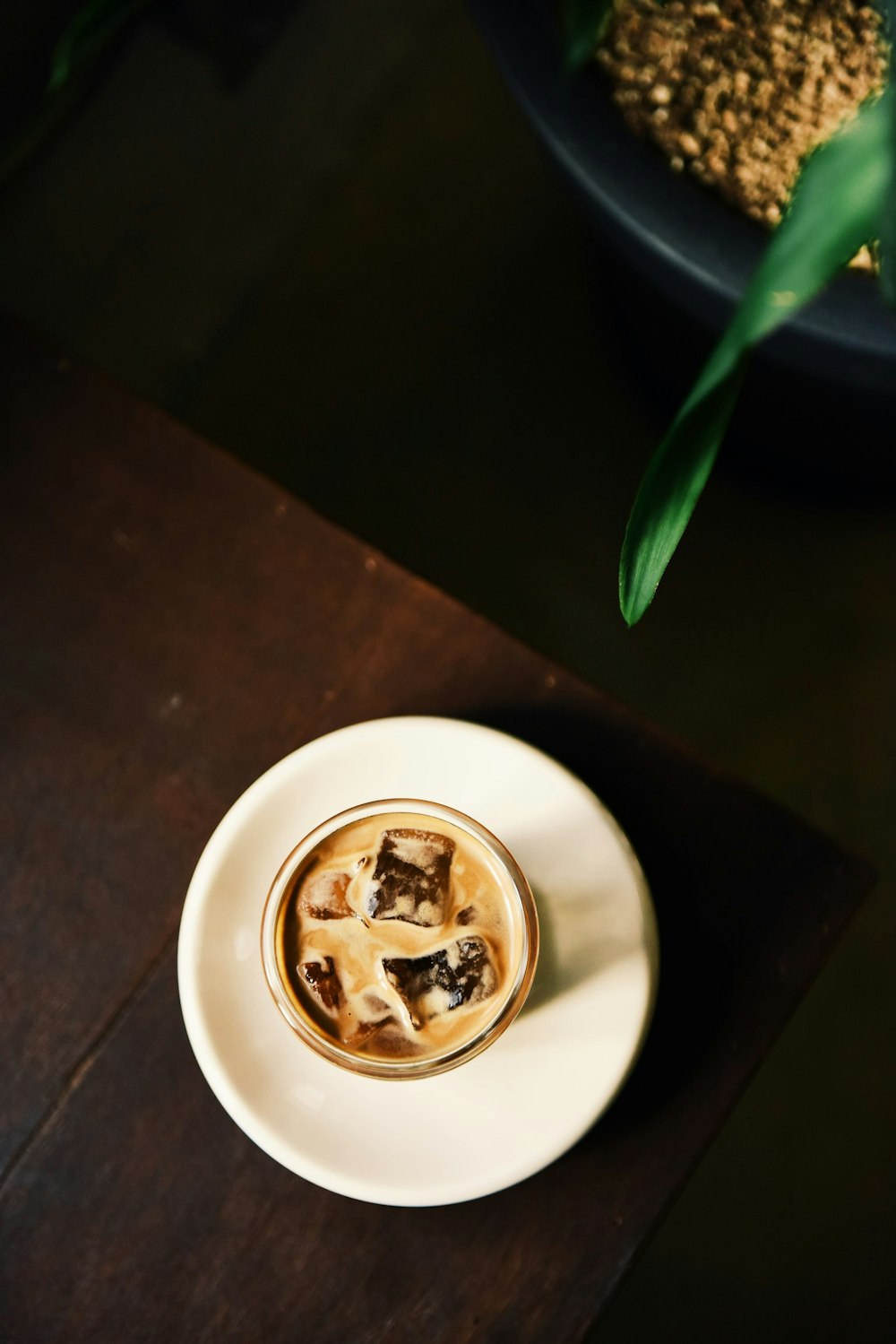 beverage with ice cubes near edge of table