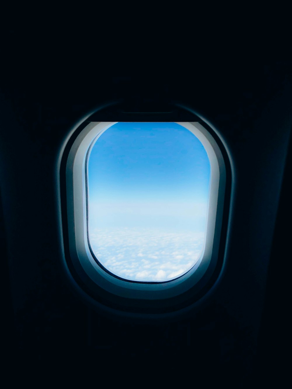 plane's window displaying clouds