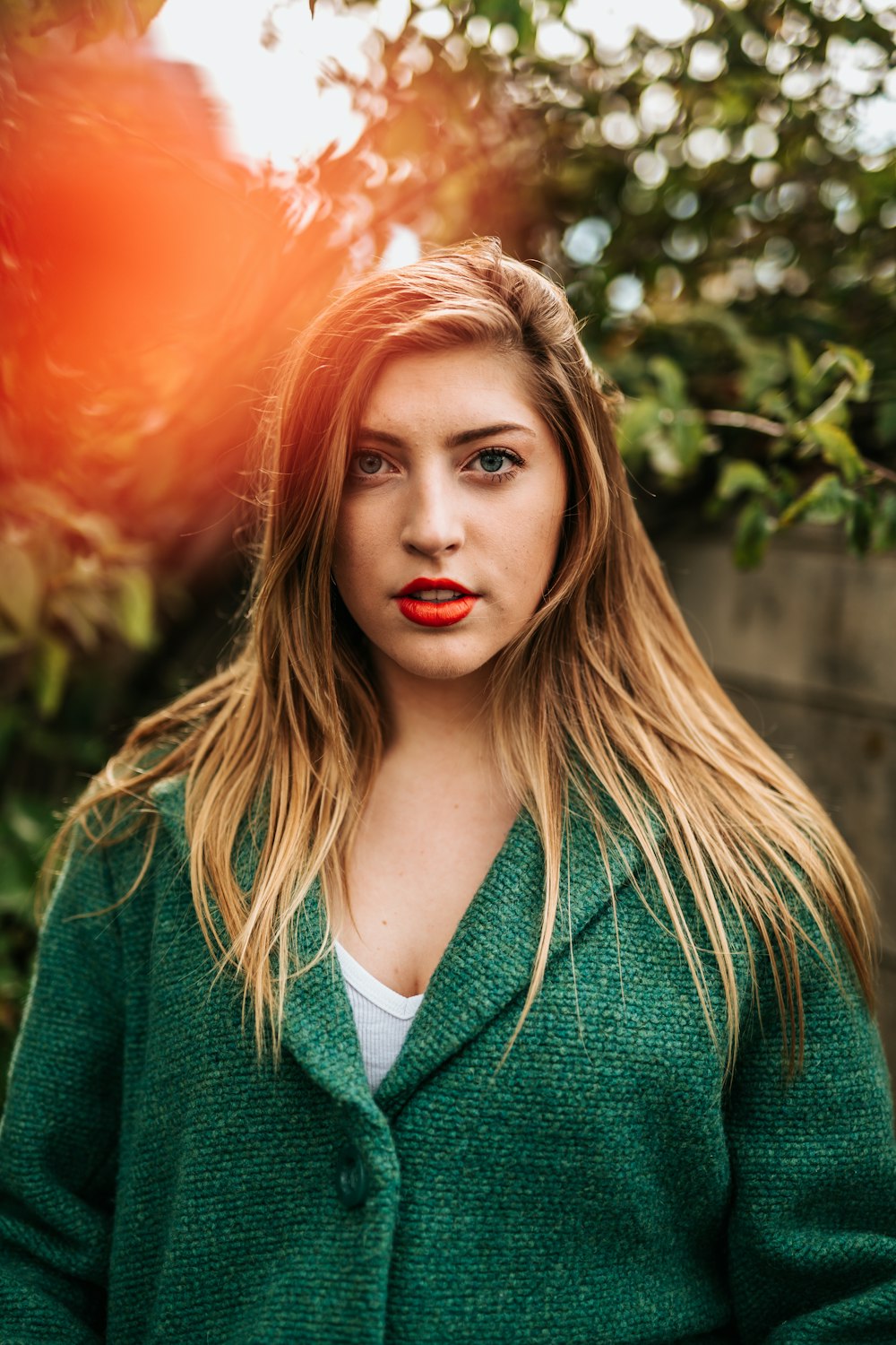 portrait photography of woman in green coat