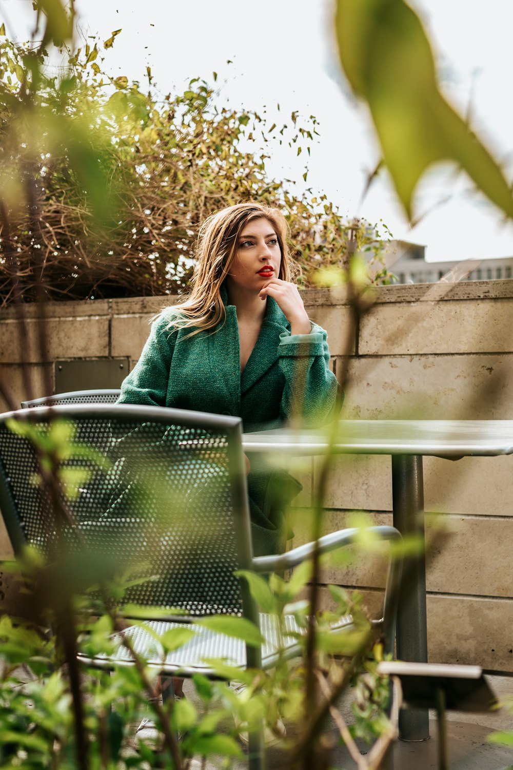 woman sitting on armchair outside during daytime