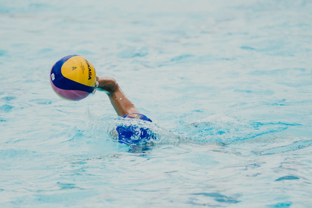 person swimming on clear water