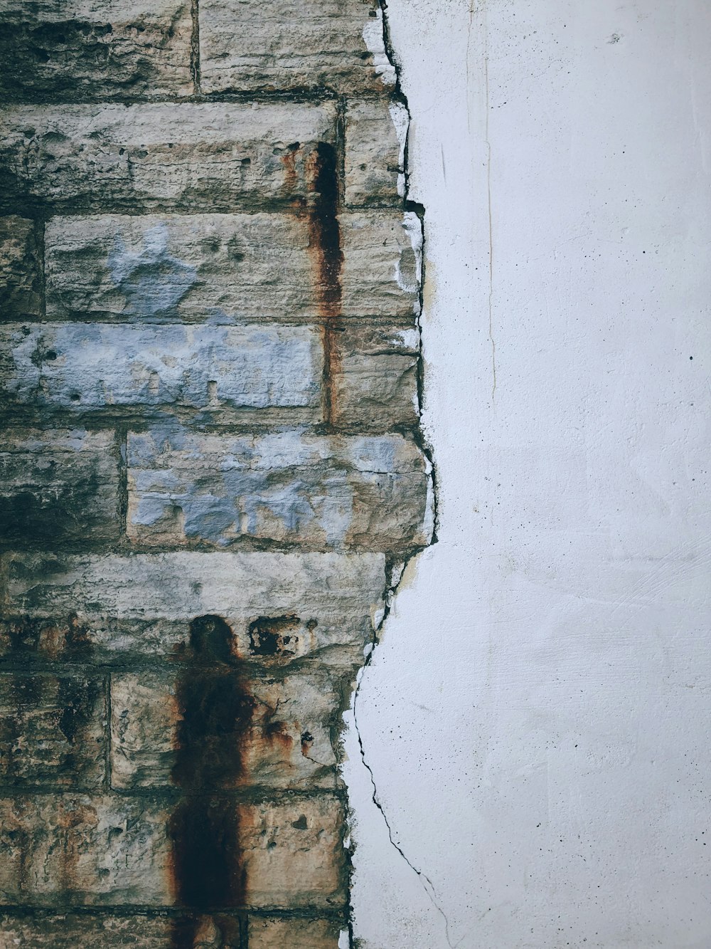 a person standing in front of a brick wall