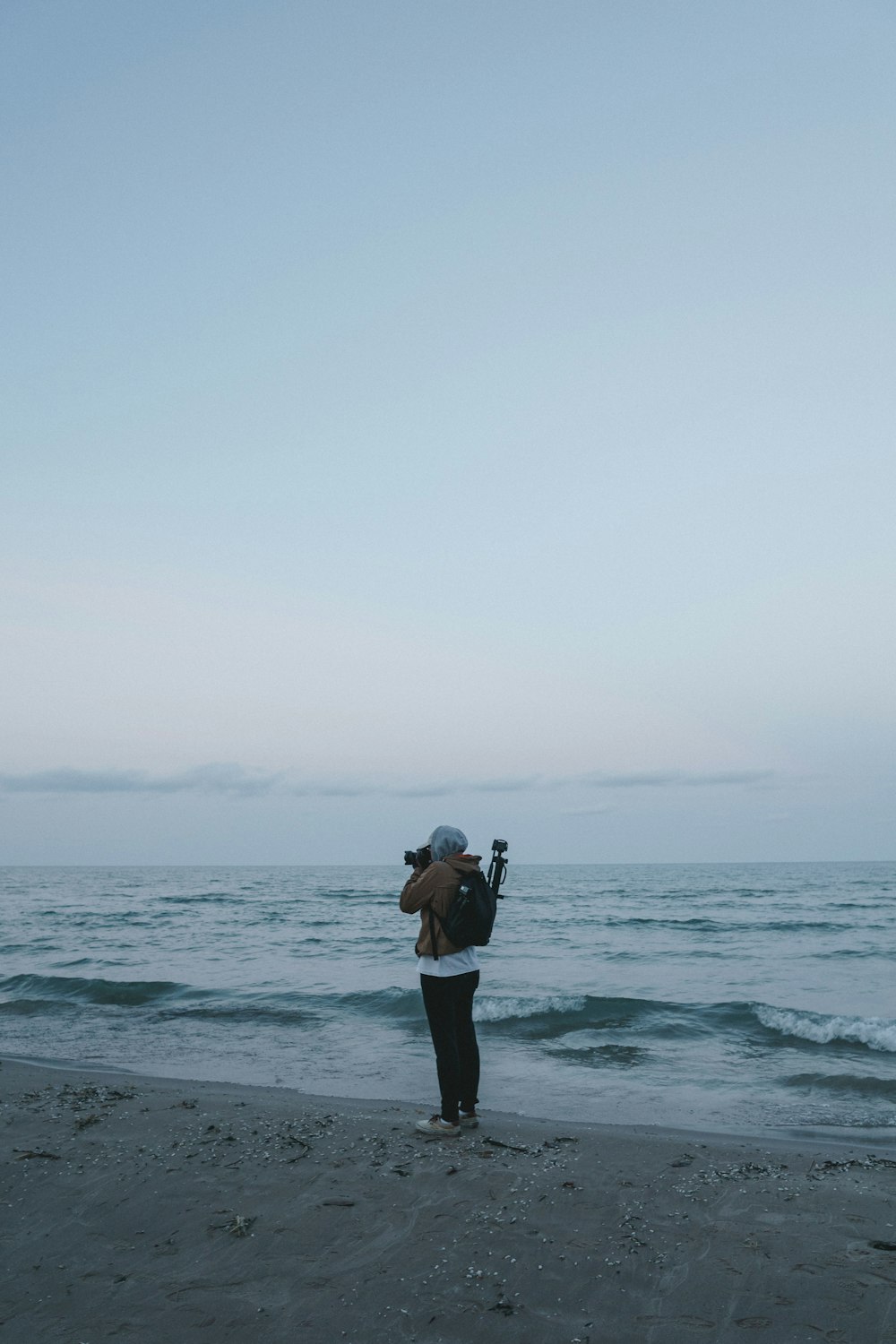 Frau, die ein Foto vom Meer macht