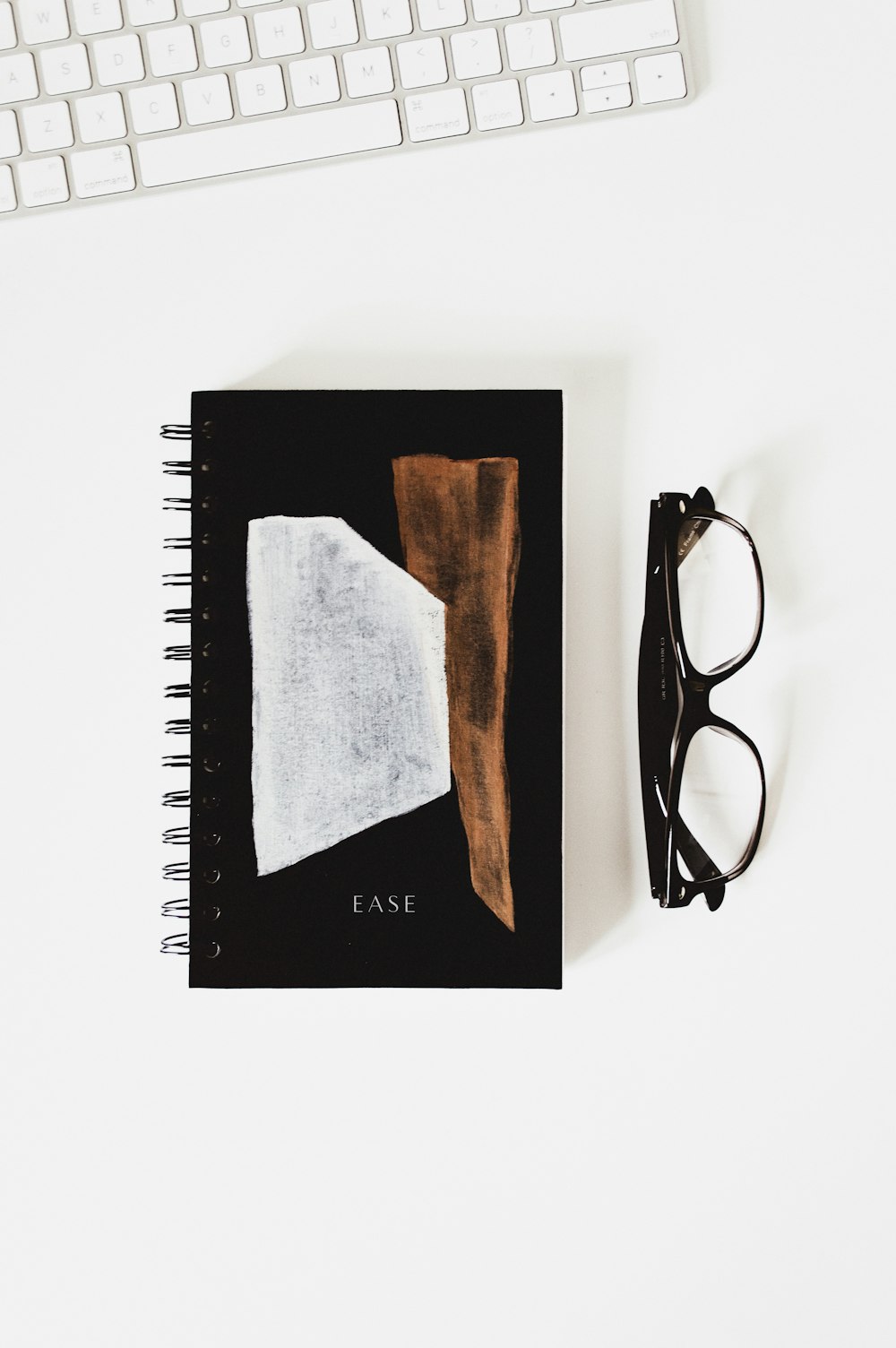 eyeglasses beside Ease book