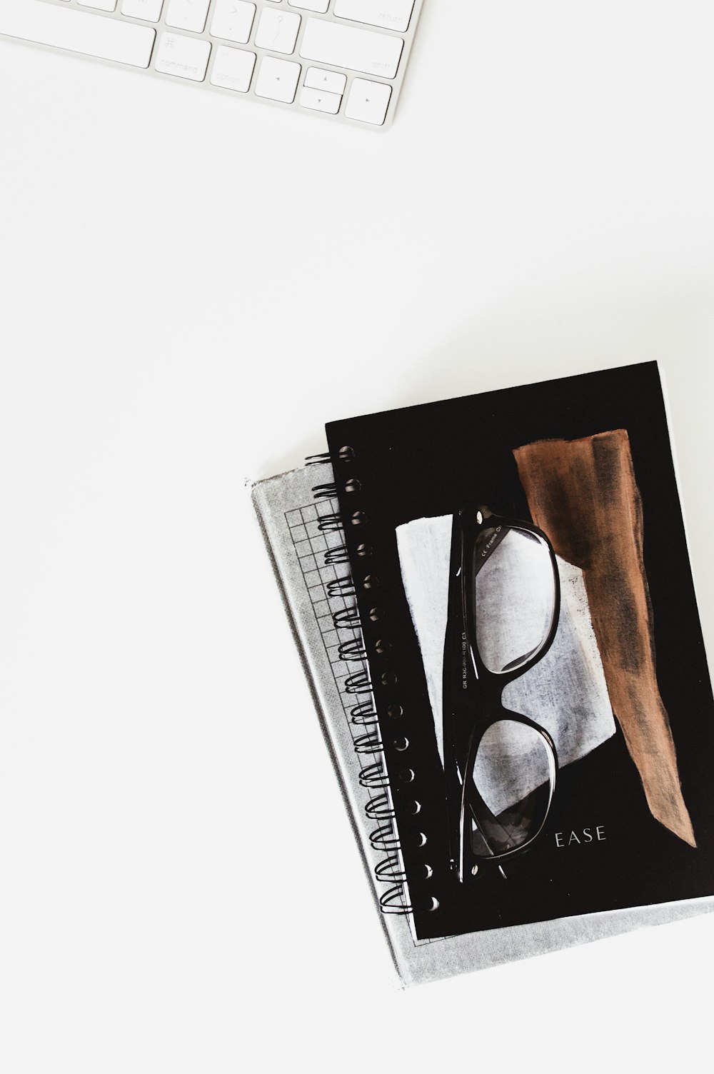 eyeglasses with black frames on black notebook