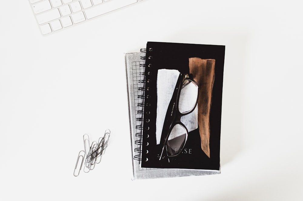 eyeglasses with black frames on book