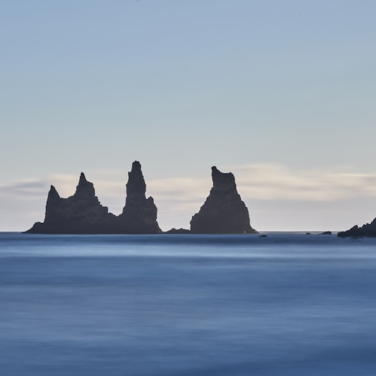 silhouette of rock formation on sea in Reynisdrangar Iceland