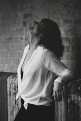gray scale woman leaning on railings