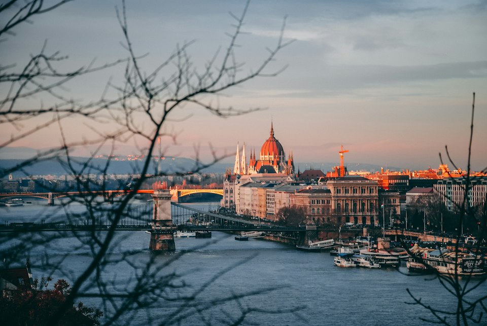 High-angle view of a domed building beside a bridge over the Danube, Budapest