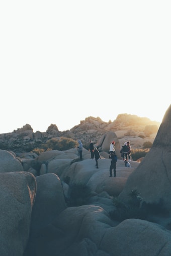 people standing on rock formations during daytime