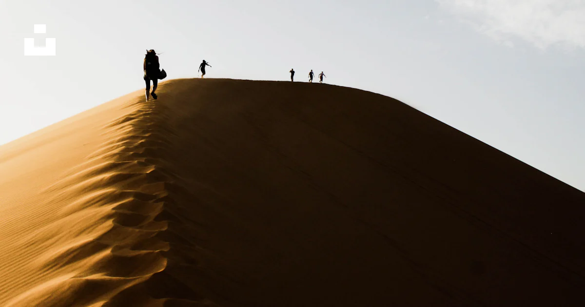 Five people standing on sand dunes during daytime photo – Free Sand ...
