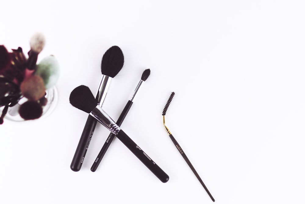 four black make-up brushes