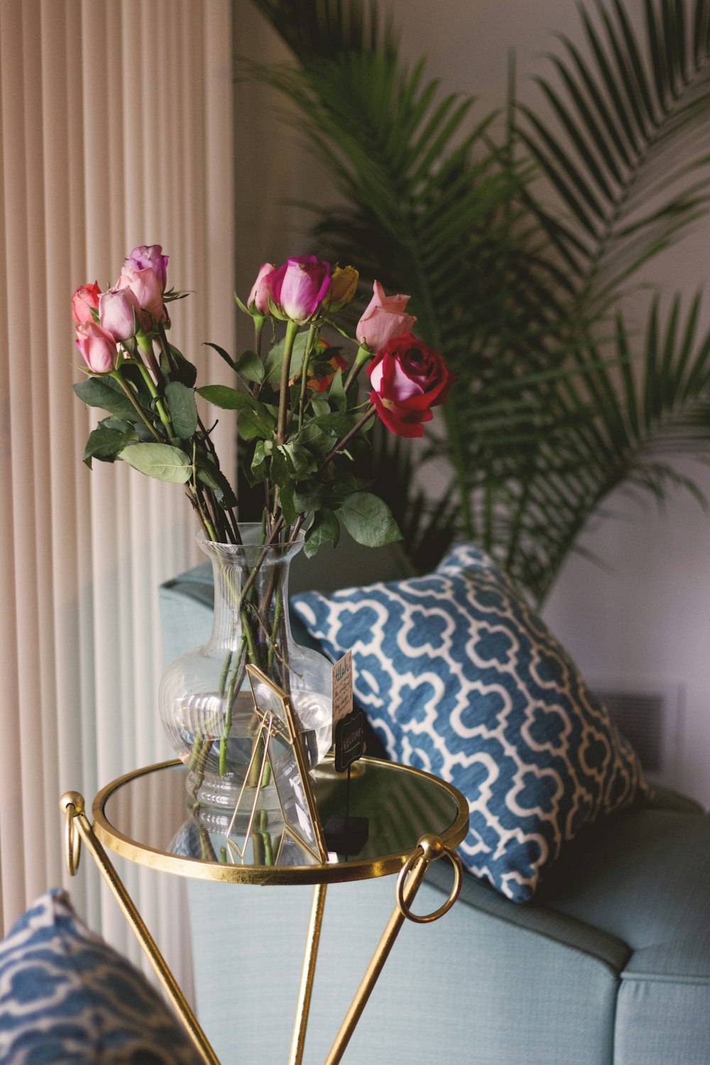 red and pink roses in clear glass vase