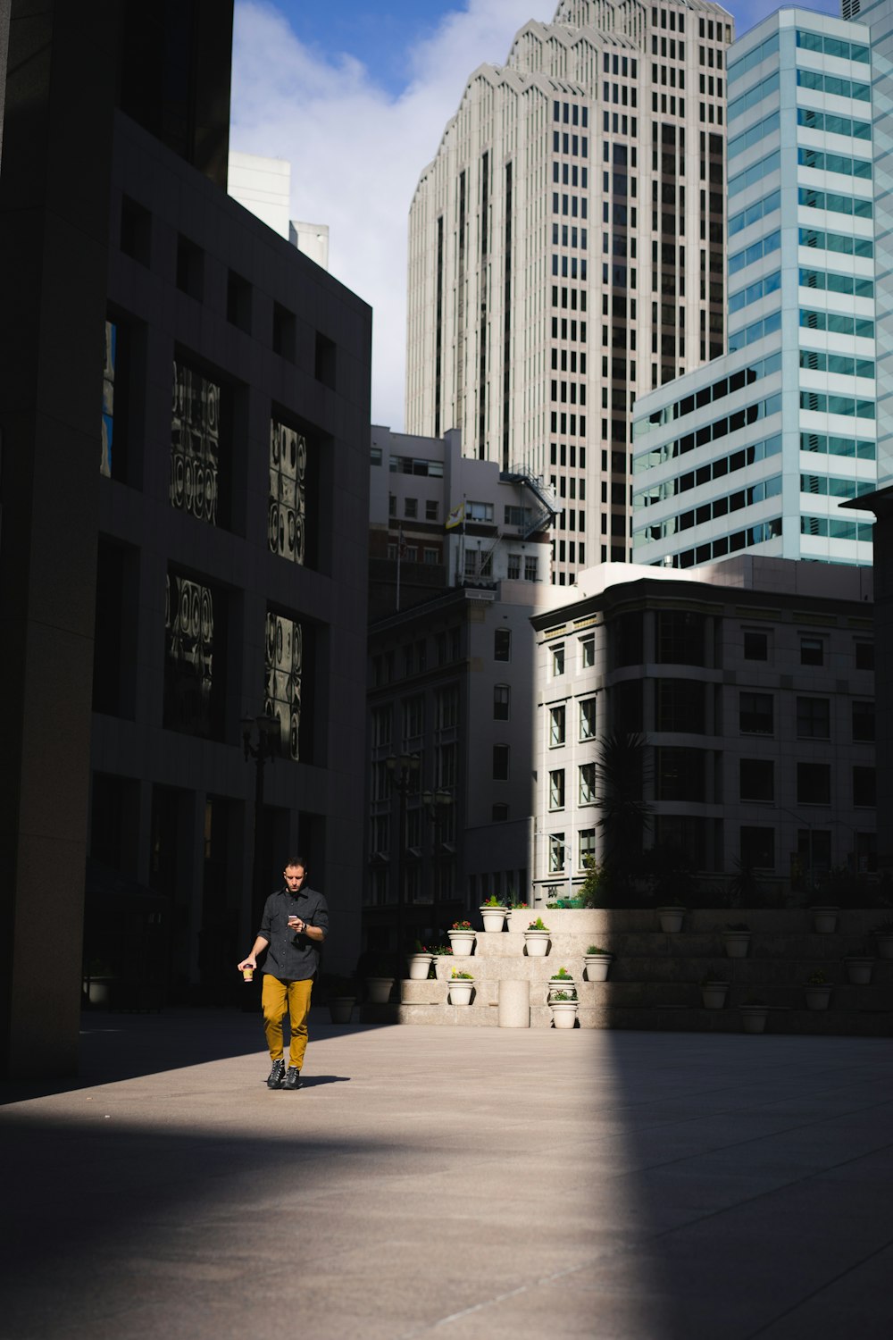 man standing beside building