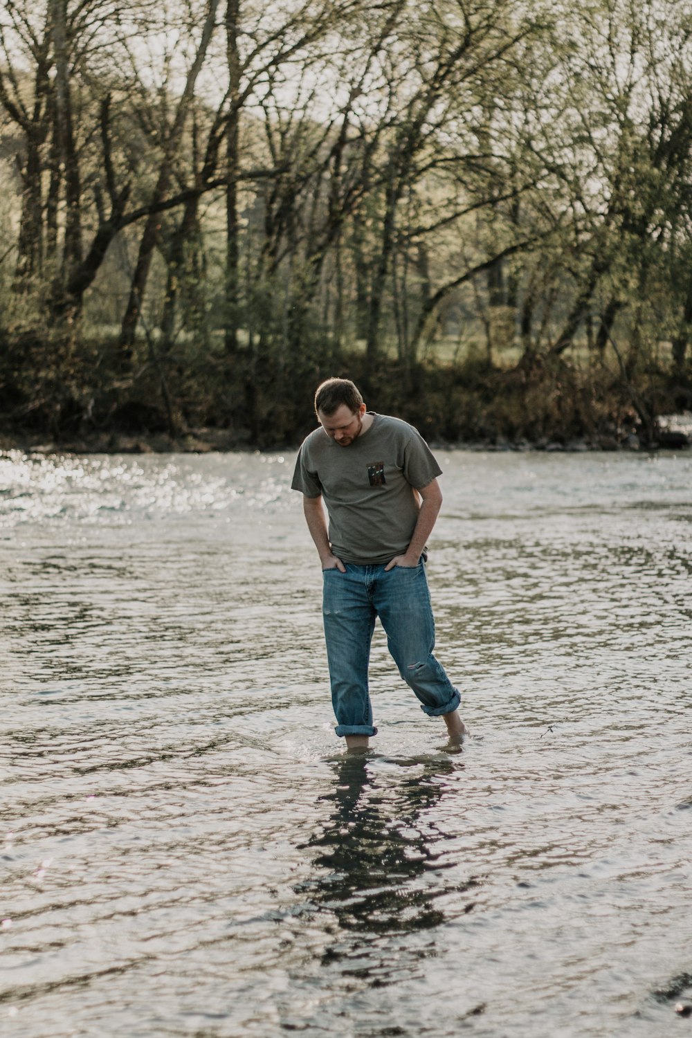 man walking in the lake at daytime