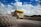 yellow truck on gray road during daytime