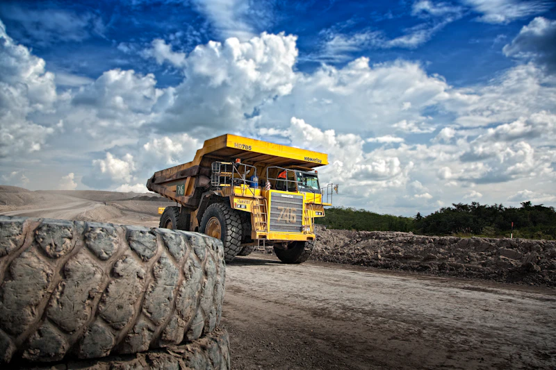 Heavy equipment convoy with escort vehicles on a highway