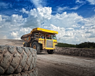 yellow truck on gray road during daytime