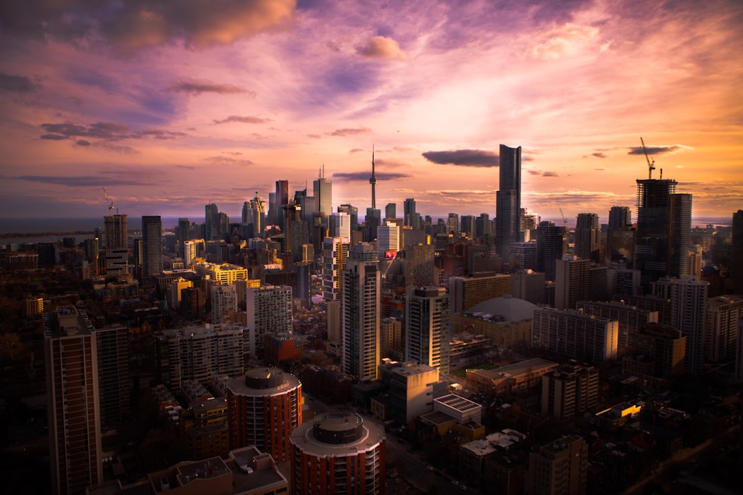 aerial photo of high rise building, A couple friends and I were walking through the streets of downtown reminiscing our summer. There was a building near one the places I visited in the summer so we decided to climb to the top. The door to the roof was unlocked so we decided to take some photos. Ended up with the brilliant thoughts that remind me of summer 2017.