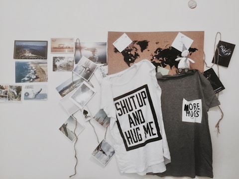 two white and gray text-printed hanging shirts