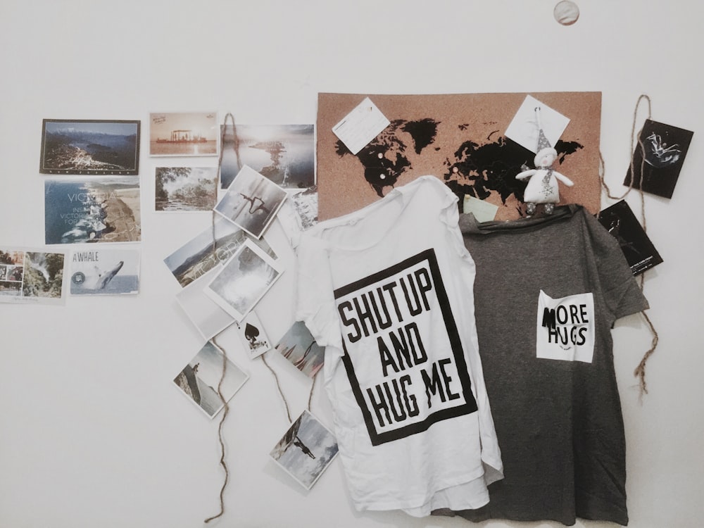 two white and gray text-printed hanging shirts