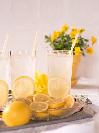 sliced lemon beside two clear drinking glasses