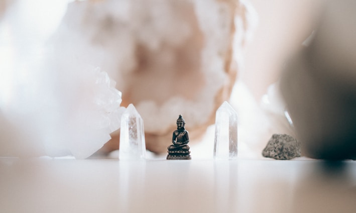 macro photography of black ceramic Gautama Buddha miniature