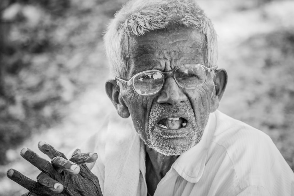 grayscale photography of man with eyeglasses