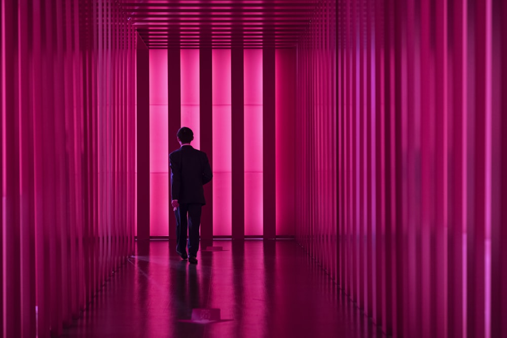 man in suit walking on corridor