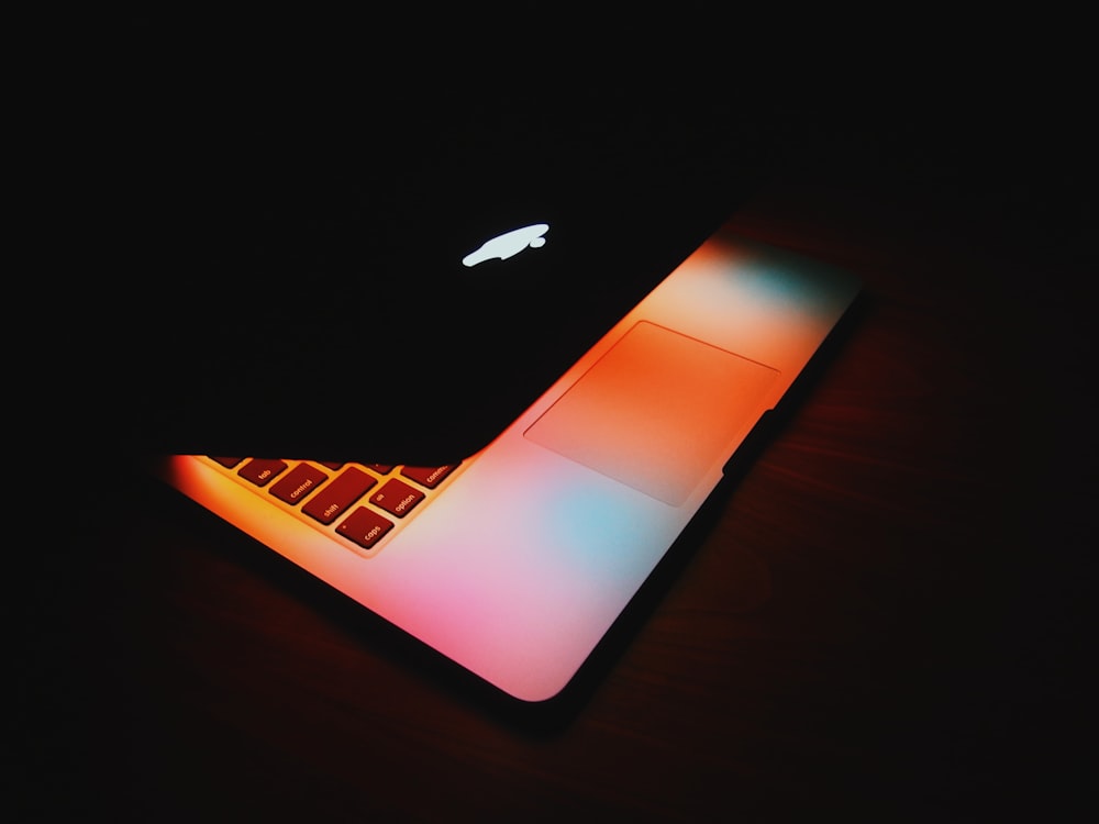 MacBook on brown wooden surface