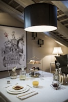 a white table topped with plates of food and drinks