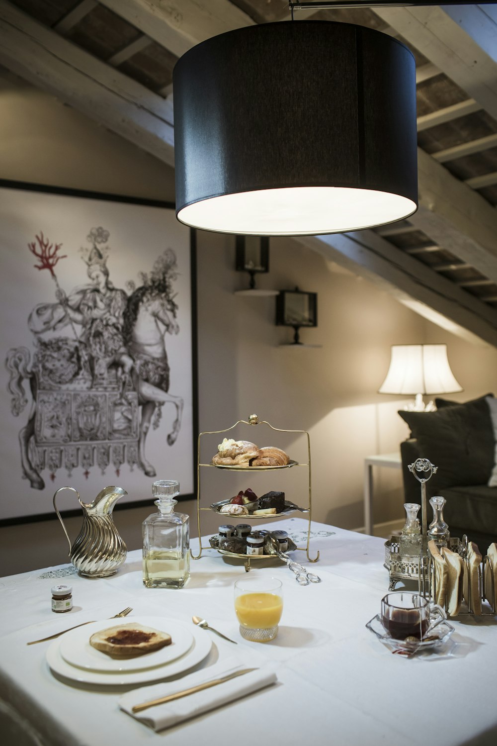 a white table topped with plates of food and drinks