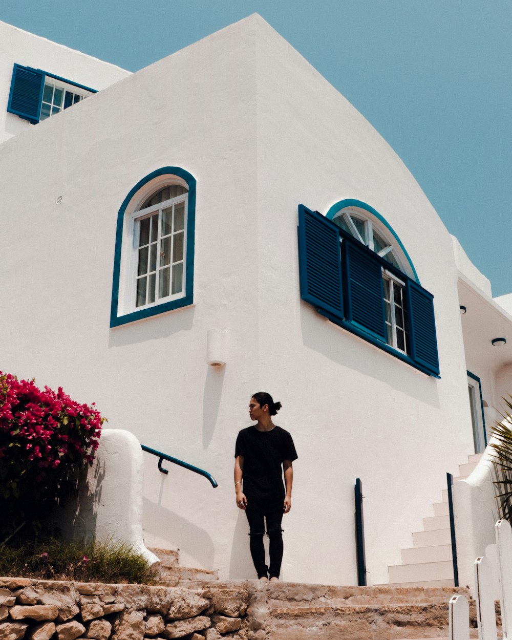 man standing near house at daytime