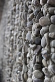 A panoramic view of a retaining wall made of stone-filled gabions blending into the natural landscape.