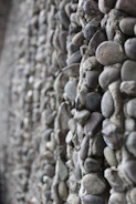 Close-up of natural andesite stone wall installation in a modern garden.
