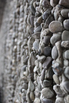 Close-up of natural andesite stone wall installation in a modern garden.