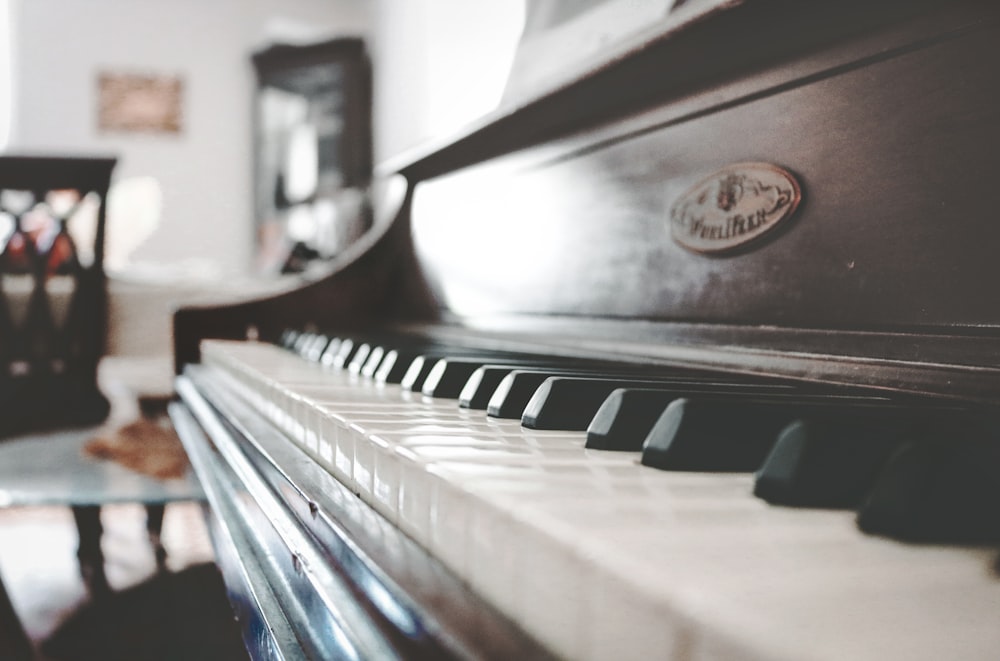 tilt shift focus photo of upright piano