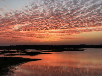 A picturesque sunset over a tranquil lake.