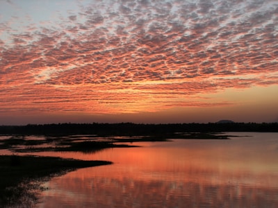 A picturesque sunset over a tranquil lake.