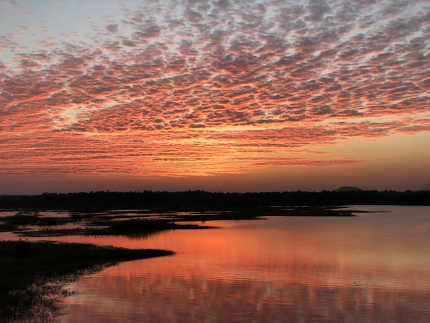 A breathtaking sunset over a tranquil lake.