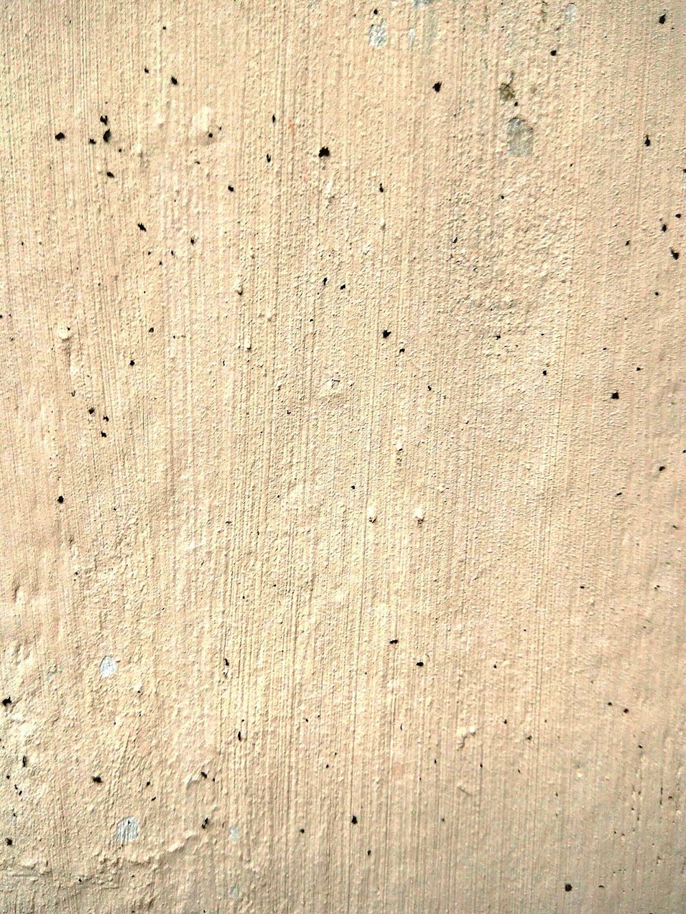 a red fire hydrant sitting on the side of a cement wall