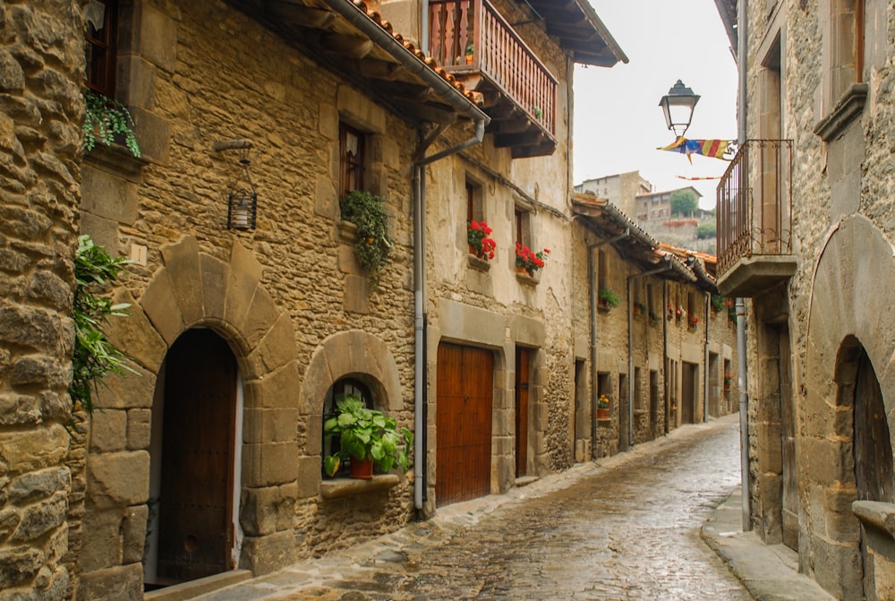 narrow road between concrete brick houses