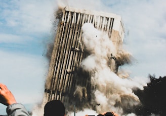 people taking photo of collapsing building