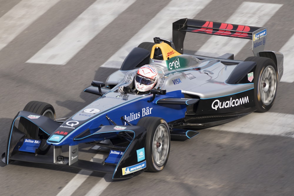 man ridding blue racing car on road